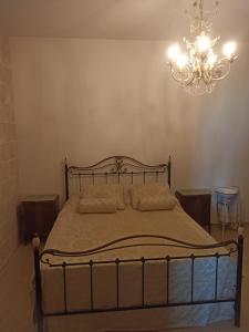 a bedroom with a bed with a chandelier at Il Vecchio Mulino in Modugno