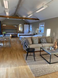 a living room with a couch and a bed at Vadstena Vandrarhem-Hostel in Vadstena