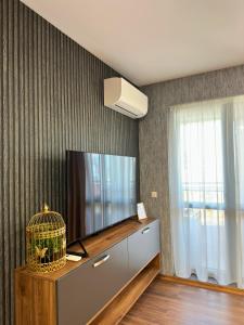 - un salon avec une télévision et une cage pour oiseaux dans l'établissement WEST POINT DELUXE SUITE, à Plovdiv