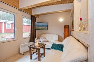 a living room with a couch and a table at Sturmmöwe in Ueckeritz