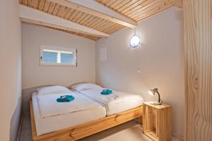 a bedroom with a bed and a lamp and a window at Sturmmöwe in Ueckeritz +12 photos