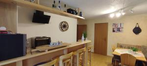 a room with a bar and a table with chairs at Sauerland-AlmWinterberg in Hallenberg