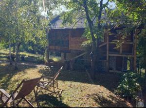 two chairs sitting in front of a log cabin at Log cabin in Belgrade