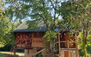 a log cabin with a tree in front of it at Log cabin in Belgrade