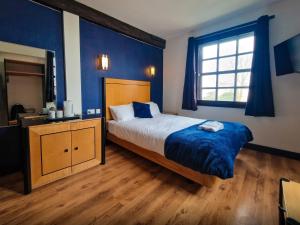 Voodi või voodid majutusasutuse Cornmill Hotel toas