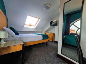 Voodi või voodid majutusasutuse Cornmill Hotel toas