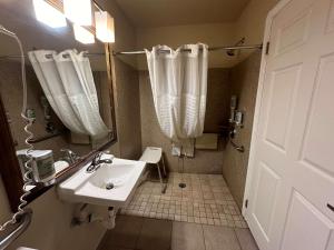 a bathroom with a sink and a shower at Best Western Tradewinds in Morro Bay