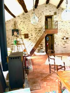 an attic room with a table and chairs in a building at Grande maison cévenole authentique in Valleraugue