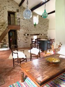 a living room with a wooden table and chairs at Grande maison cévenole authentique in Valleraugue +32 photos