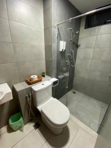 a bathroom with a toilet and a glass shower at K Avenue with Peak Escapes A708 in Donggongon