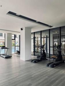 a gym with treadmills and exercise bikes in a room at K Avenue with Peak Escapes A708 in Donggongon
