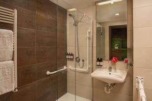 a bathroom with a shower and a sink at NH Orio Al Serio in Orio al Serio