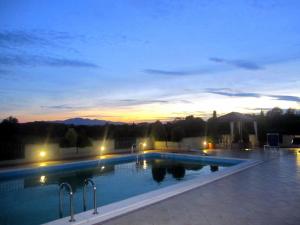 una piscina por la noche con puesta de sol en Ferienwohnung für 3 Personen ca 32 qm in Poggio Alla Cavalla, Toskana Provinz Pistoia, en Lamporecchio