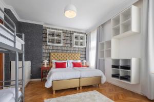 a bedroom with a large bed with red pillows at Pytloun Villa Liberec in Liberec