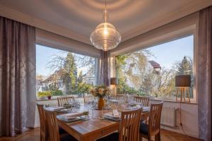 a dining room with a table and a large window at Pytloun Villa Liberec in Liberec