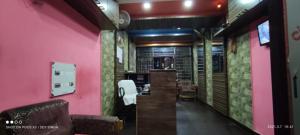 a room with pink walls and chairs and a bar at Hotel Samrat Palace Puri Near Sea Beach Excellent Service in Puri
