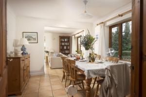 a kitchen and dining room with a table and chairs at Godolphin in Wadebridge