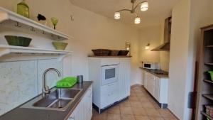 a kitchen with a sink and a counter top at Haus am See mit Sauna 