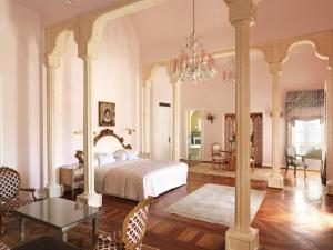 a bedroom with a bed and a chandelier at La Maison Bleue El Gouna in Hurghada