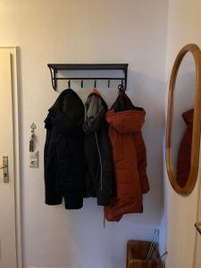 a rack of jackets hanging on a wall at Friisk Aran in Alkersum