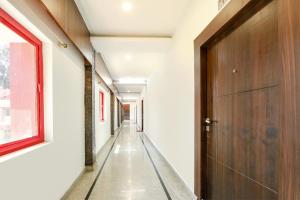 an empty hallway with a door and a window at FabHotel Prime JVS Beauty Green Resorts in Venkatāpur