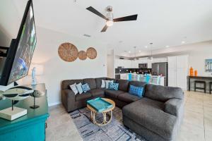a living room with a couch and a flat screen tv at 3141 Paradox Circle 406 in Kissimmee
