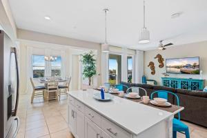a kitchen and living room with a couch and a table at 3141 Paradox Circle 406 in Kissimmee