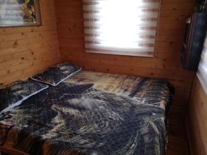 a bedroom with a bed in a log cabin at Family Summer House in Jurmala in Jūrmala