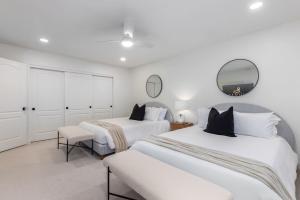 a bedroom with two beds and a mirror at Anderson LUX Estate Private Bar&Pool Sleeps 12 in Phoenix