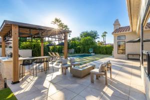 a patio with a bar and a pool at Anderson LUX Estate Private Bar&Pool Sleeps 12 in Phoenix