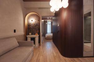 a living room with a couch and a bedroom at Zenith Premium Suites in Thessaloniki