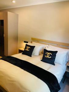 a bed with two black and white pillows on it at Executive Studio Apartment in Sandton in Johannesburg