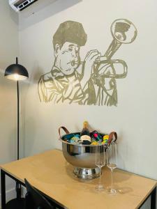 a bowl on a table with a painting on the wall at Executive Studio Apartment in Sandton in Johannesburg