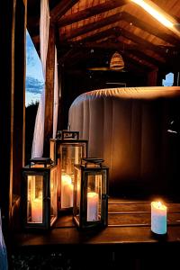 a group of candles sitting on a table with a tub at Liva Park Glamp in Liwa