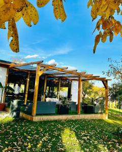 a pavilion in a park with autumn leaves at Agropa Rooms & Garden Events in Bistriţa