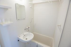 a white bathroom with a sink and a mirror at Walk to Nishi-Nippori/Sendagi/Nippori sta. DBoY in Tokyo
