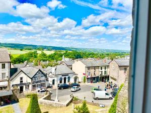 a view of a town with cars parked on the street at Hay View Lodges - Barn End in Hay-on-Wye