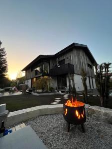 a fire pit in front of a house at Anderswo Bad Aibling in Bad Aibling