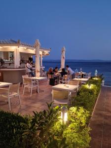 a restaurant with a view of the ocean at night at Porto Xronia in Khrónia
