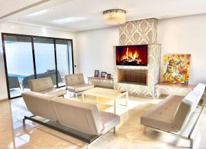 a living room with a couch and a fireplace at Luxury villa with private pool in Casablanca