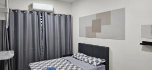 a bedroom with a bed and a gray shower curtain at TELUK INTAN LANDED LUXURY HOMESTAY 3BEDROOM in Teluk Intan