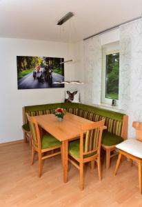 a dining room with a wooden table and chairs at Appartement in Saig mit Garten und Grill in Lenzkirch
