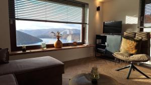 a living room with a large window with a view at Haus Blick am Edersee 4P in Waldeck