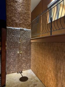 a bathroom with a shower with a stone wall at Terpsichore's House in Sami +21 photos