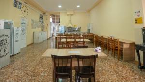 a restaurant with tables and chairs in a room at Hostel Mandaria in Kutaisi