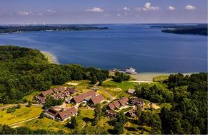 an aerial view of a house by the water at BEECH Resort Plauer See in Plau am See