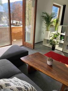 a living room with a couch and a coffee table at Studio für 2 Personen 1 Kind ca 40 qm in Feld am See, Kärnten Brennsee in Feld am See