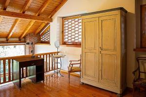 Zimmer mit einem Schreibtisch und einem Holzschrank. in der Unterkunft Ferienwohnung für 4 Personen ca 65 m in Pisano, Piemont Lago Maggiore in Pisano