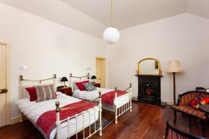 a bedroom with two beds and a fireplace at Clare Island Lighthouse in Westport