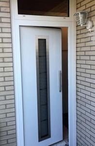 a white door with a mirror on a house at Bungalow 5566 in Tossens in Butjadingen OT Tossens